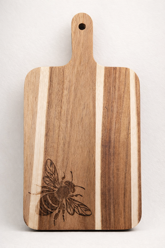 Wooden cutting board with a bee engraving on a white background
